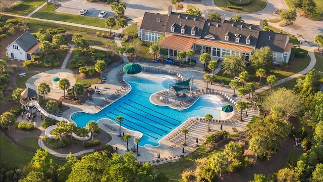 view of pool with a water slide and a patio area