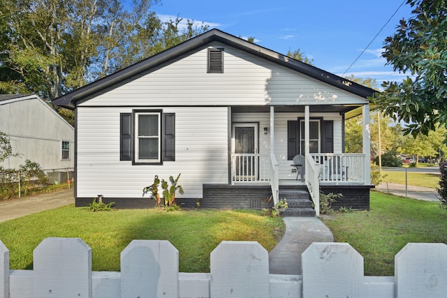 bungalow-style house with covered porch and a front lawn