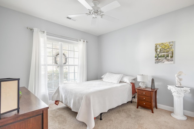 bedroom featuring light colored carpet and ceiling fan