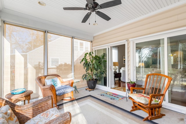 sunroom / solarium featuring ceiling fan