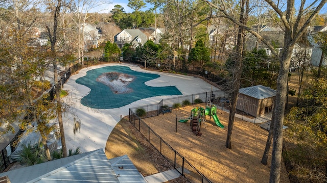 view of swimming pool featuring a playground