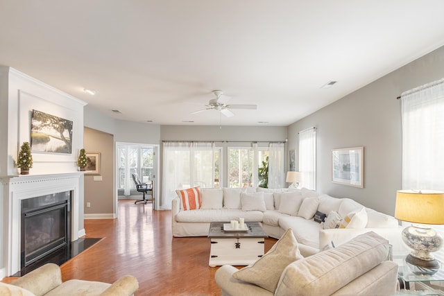 living room with hardwood / wood-style floors and ceiling fan