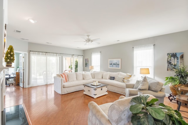 living room featuring ceiling fan and light wood-type flooring