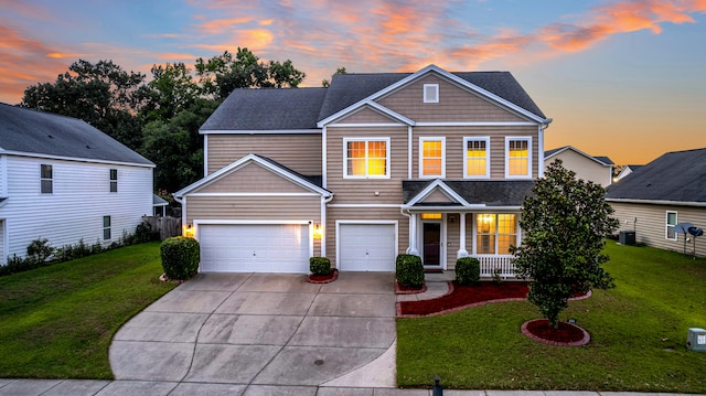 view of front of property featuring a porch, a yard, a garage, and central air condition unit