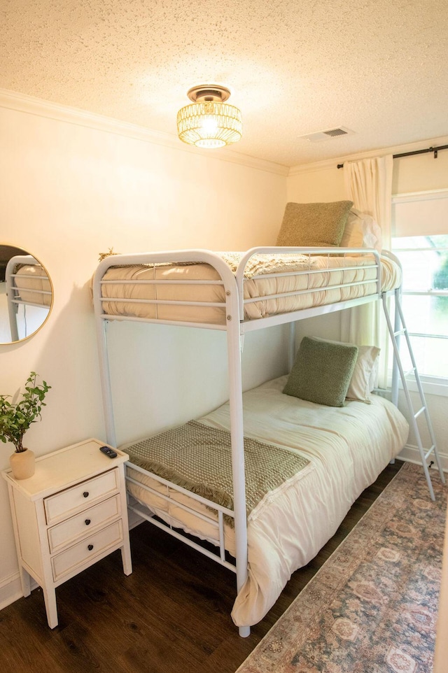 1137 Dickson Ave, Hanahan, SC 29410 - bedroom featuring a textured ceiling, ornamental molding, and wood finished floors