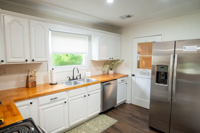 1137 Dickson Ave, Hanahan, SC 29410 - kitchen with stainless steel appliances, wood counters, white cabinetry, ornamental molding, and dark wood-style flooring