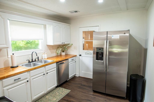 1137 Dickson Ave, Hanahan, SC 29410 - kitchen with stainless steel appliances, butcher block countertops, white cabinets, dark wood-type flooring, and ornamental molding