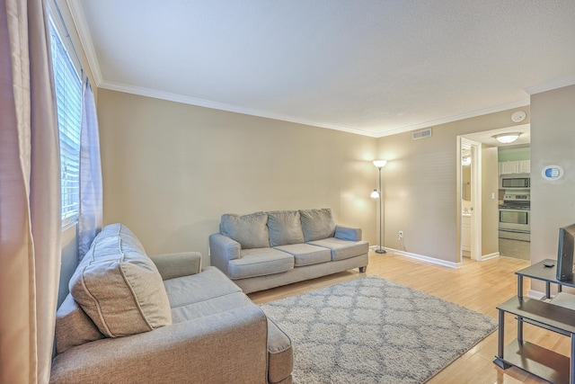 living room featuring light wood-type flooring and ornamental molding