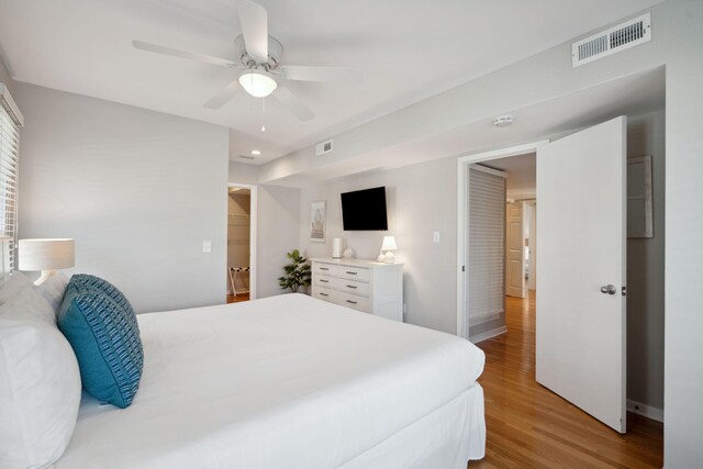 bedroom with ceiling fan and light hardwood / wood-style floors