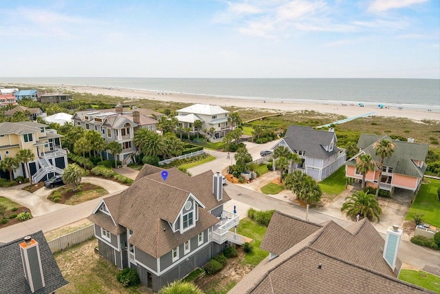 birds eye view of property featuring a view of the beach and a water view