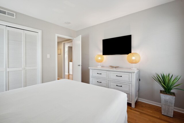 bedroom featuring hardwood / wood-style floors and a closet