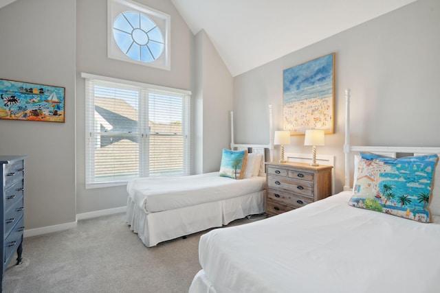 carpeted bedroom with lofted ceiling