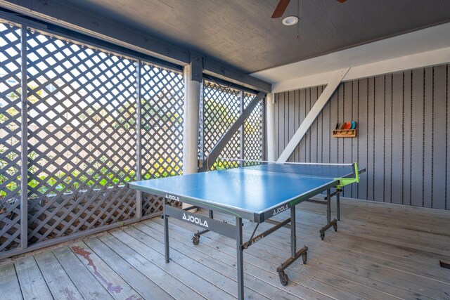 game room with wood walls, hardwood / wood-style floors, ceiling fan, and wood ceiling