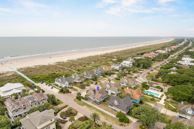 birds eye view of property with a view of the beach and a water view