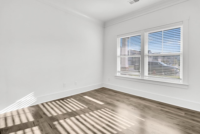 unfurnished room with ornamental molding, dark hardwood / wood-style flooring, and a healthy amount of sunlight