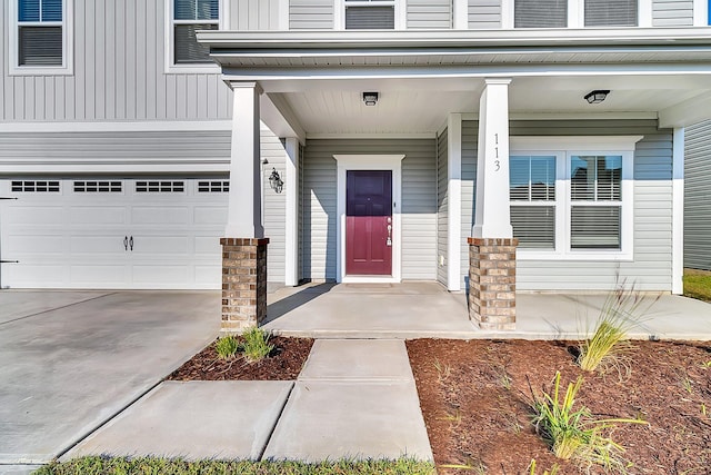 property entrance featuring covered porch and a garage