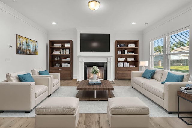 living room with crown molding and light hardwood / wood-style flooring