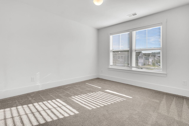 spare room featuring carpet flooring and a healthy amount of sunlight