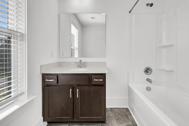 bathroom featuring wood-type flooring, vanity, and shower / bathtub combination