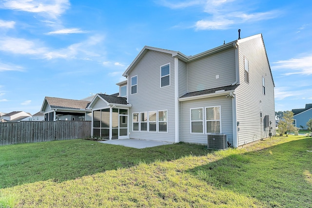 back of property featuring a yard, central AC, and a patio