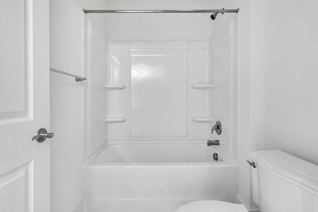 bathroom with bathing tub / shower combination and toilet