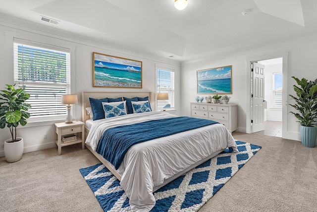 bedroom with light colored carpet and ensuite bathroom