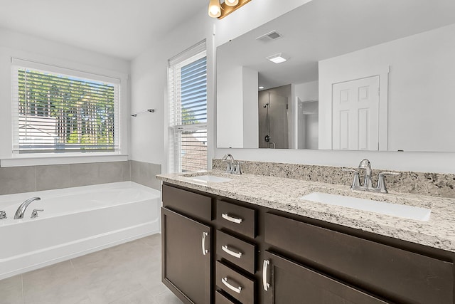 bathroom featuring vanity, separate shower and tub, tile patterned flooring, and a wealth of natural light