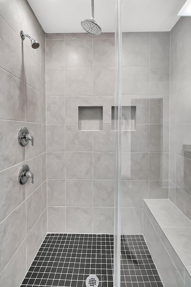 bathroom with a tile shower