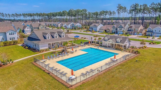 view of pool featuring a yard and a patio