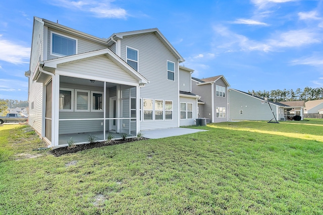 back of property with a patio, a lawn, and central AC unit