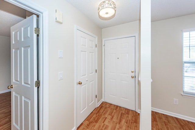 entryway featuring a textured ceiling and light wood-type flooring