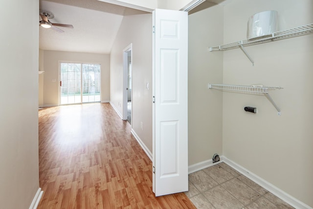 laundry room with ceiling fan and light hardwood / wood-style floors