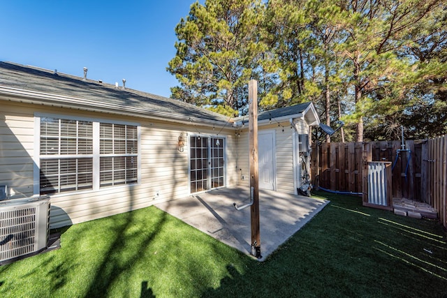 rear view of house featuring a lawn and a patio area