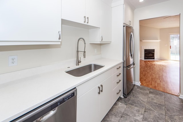 kitchen with sink, white cabinets, and appliances with stainless steel finishes