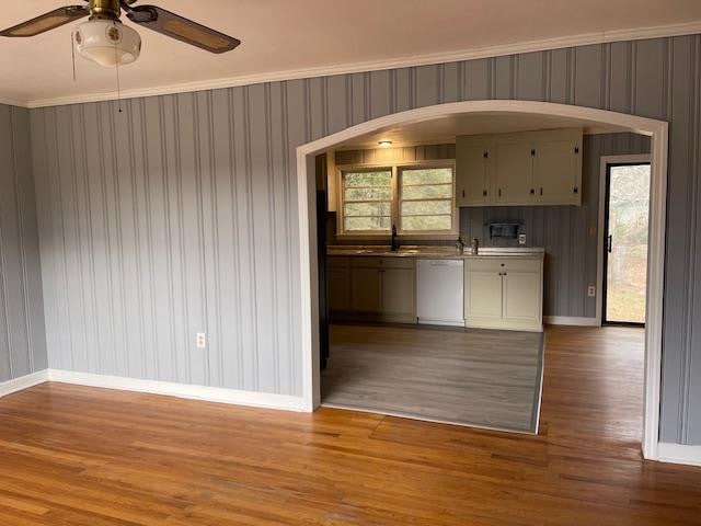 bar featuring ornamental molding, hardwood / wood-style floors, and dishwashing machine