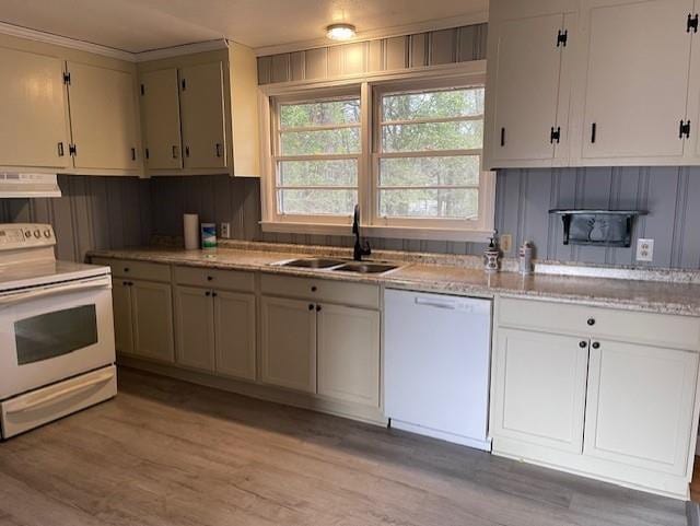 kitchen featuring white appliances, light hardwood / wood-style floors, extractor fan, and sink