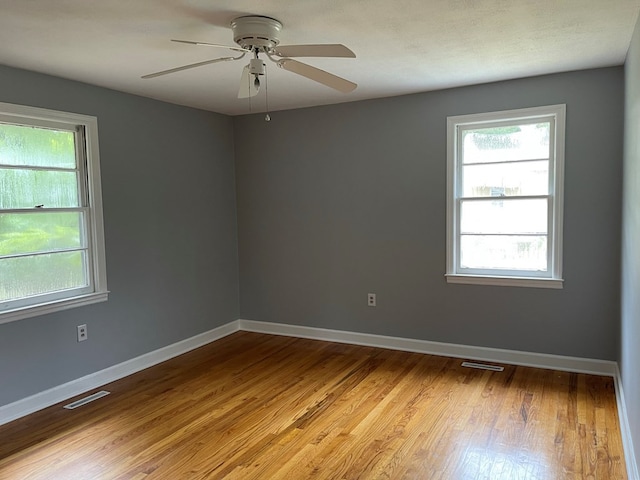 spare room with ceiling fan and light hardwood / wood-style flooring