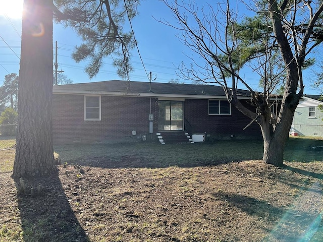 back of house with a lawn