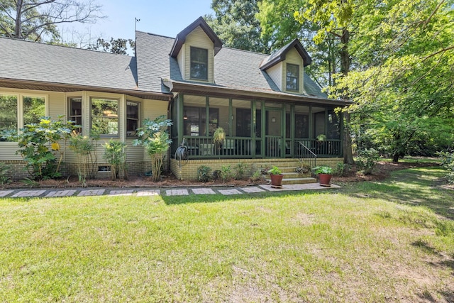 2144 Pinopolis Rd, Pinopolis, SC 29469 - rear view of property featuring a lawn, a shingled roof, and a sunroom