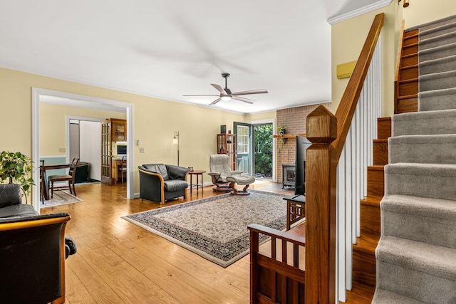 2144 Pinopolis Rd, Pinopolis, SC 29469 - living room featuring ceiling fan, light wood-style flooring, ornamental molding, and stairway