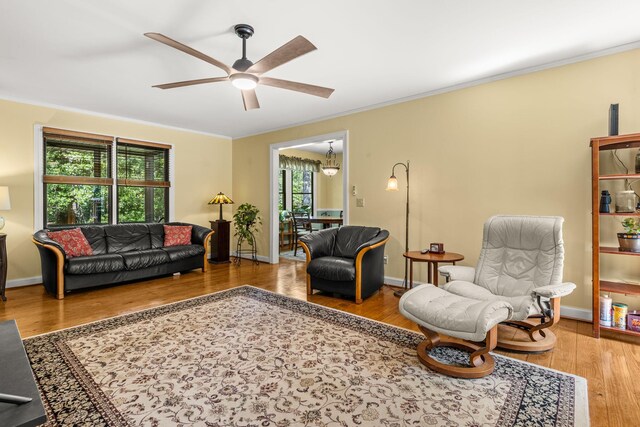 2144 Pinopolis Rd, Pinopolis, SC 29469 - living area with wood finished floors, ornamental molding, baseboards, and ceiling fan