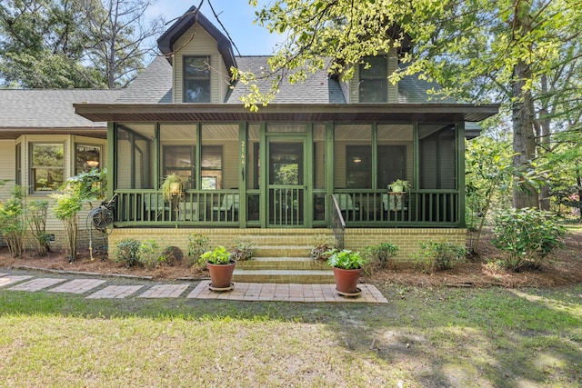 2144 Pinopolis Rd, Pinopolis, SC 29469 - view of front facade with a front lawn, roof with shingles, and a sunroom