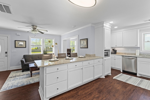 kitchen with dark wood-type flooring, dishwasher, visible vents, and ceiling fan