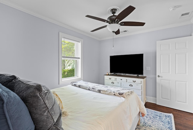 bedroom with dark wood-style floors, crown molding, and visible vents