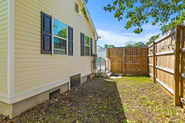 view of yard with a gate, entry steps, and fence