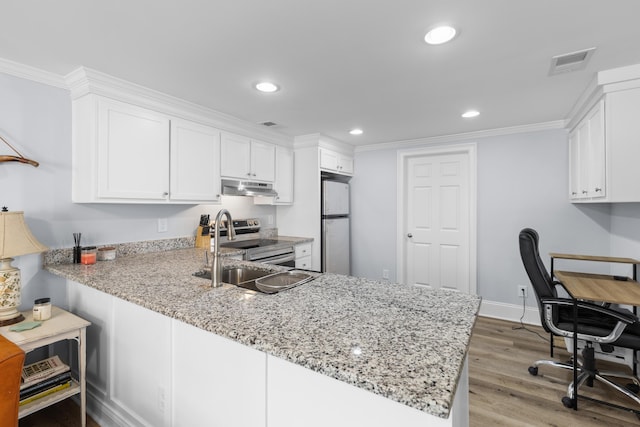 kitchen with under cabinet range hood, visible vents, a sink, appliances with stainless steel finishes, and white cabinetry