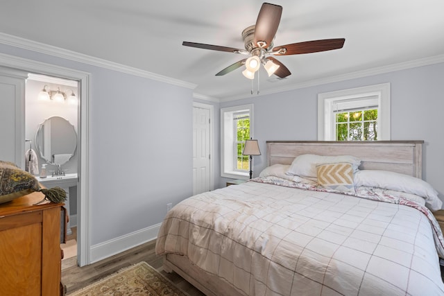 bedroom featuring wood finished floors, a closet, ceiling fan, baseboards, and ornamental molding