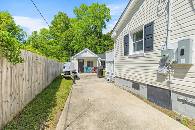 view of side of home with fence, crawl space, and an outbuilding