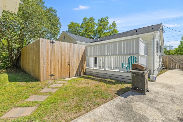 exterior space with a patio area, a gate, fence, and a yard