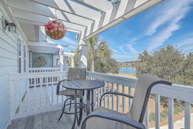 balcony featuring a pergola and a deck with water view